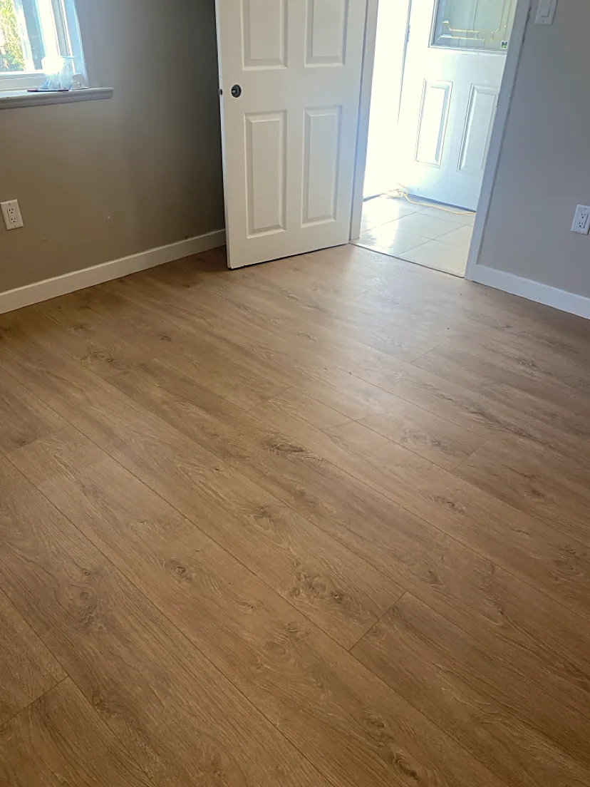 Bright bedroom with finished light wood flooring